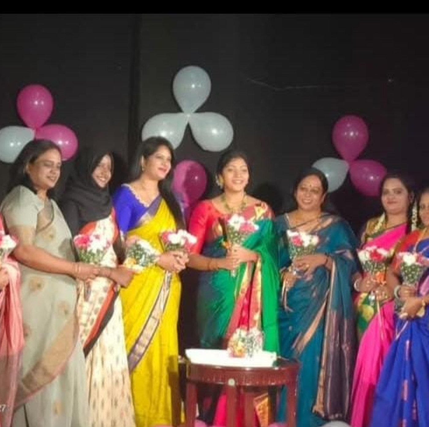 Women celebrated with bouquets at a Mamatheya Madilu Social Foundation event